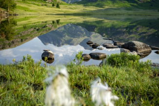 mountain-landscape-reflected-in-a-calm-lake.jpg Mountain landscape reflected in a calm lake